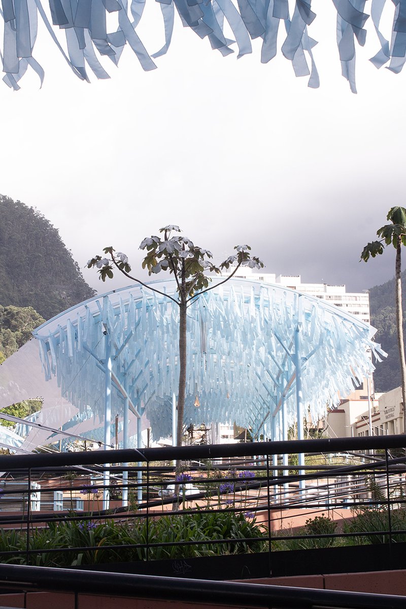 blue fabric fragments dance with the wind on modular cultural pavilion in colombia