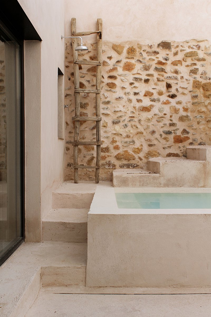 stone and clay rebuild former rural stable as a seasonal refuge in spanish countryside